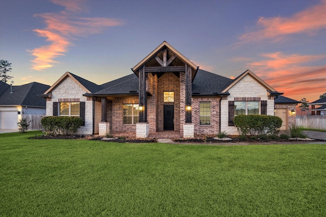 view of front of house featuring a garage and a yard