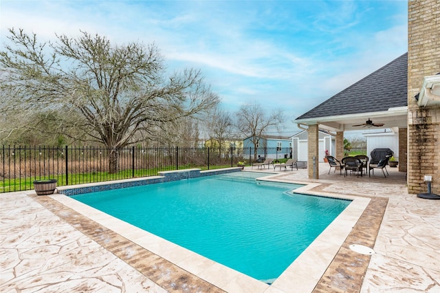 view of pool with a patio, pool water feature, and ceiling fan