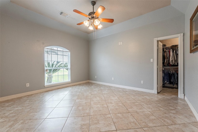 spare room featuring light tile patterned floors and ceiling fan