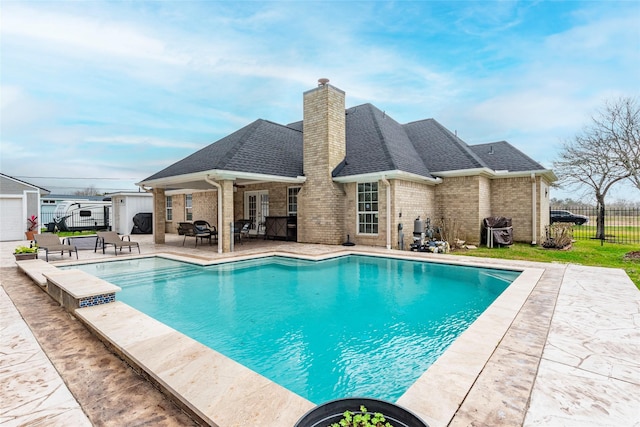 1027 27th St, Dickinson, TX 77539 - view of swimming pool featuring an outbuilding, grilling area, and a patio