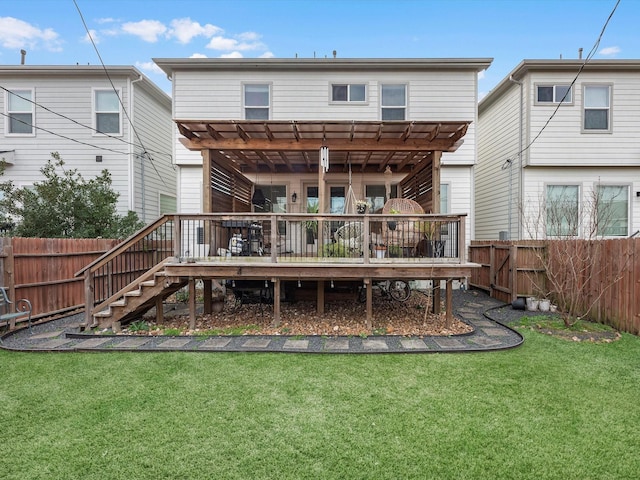 rear view of house featuring a pergola, a deck, and a lawn