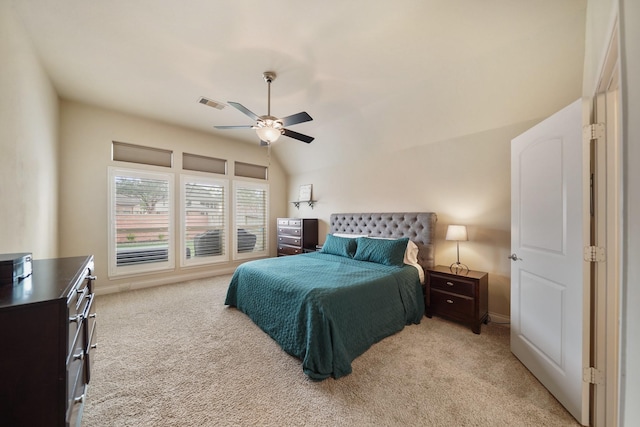 bedroom with ceiling fan, light colored carpet, and vaulted ceiling