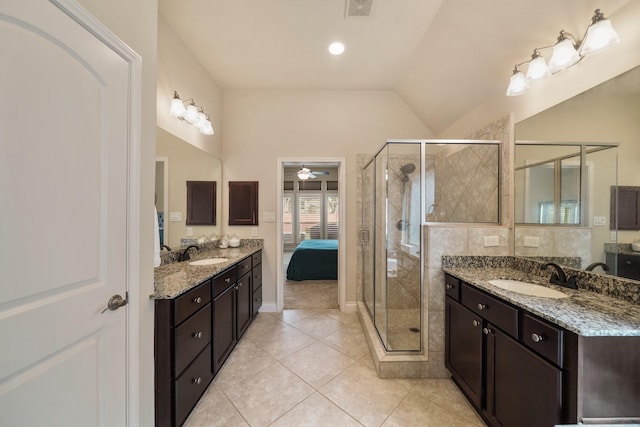 bathroom with tile patterned floors, a shower with shower door, vaulted ceiling, vanity, and ceiling fan