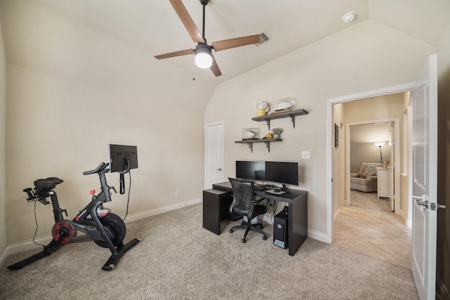 carpeted office with lofted ceiling and ceiling fan