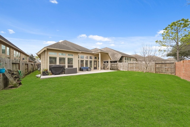 rear view of house with a patio area and a lawn