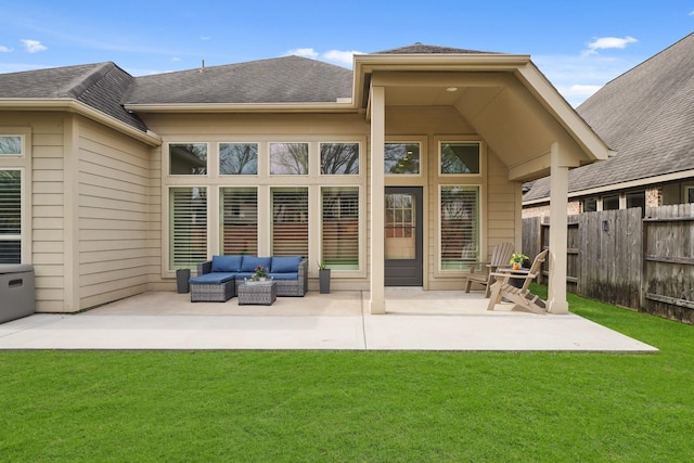 back of property featuring a yard, an outdoor hangout area, and a patio area