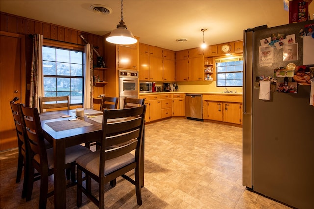 dining area featuring sink and wooden walls