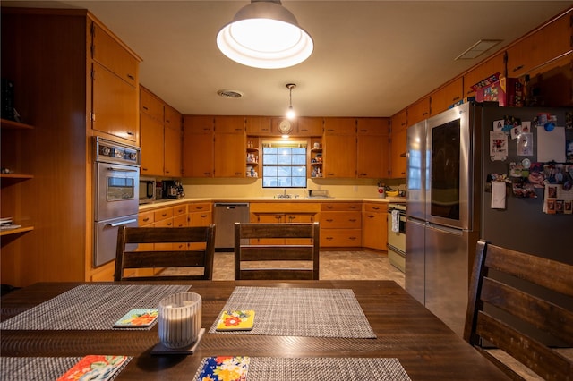 kitchen featuring stainless steel appliances and hanging light fixtures