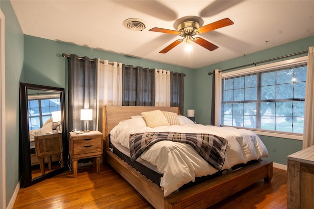 bedroom with ceiling fan and hardwood / wood-style floors