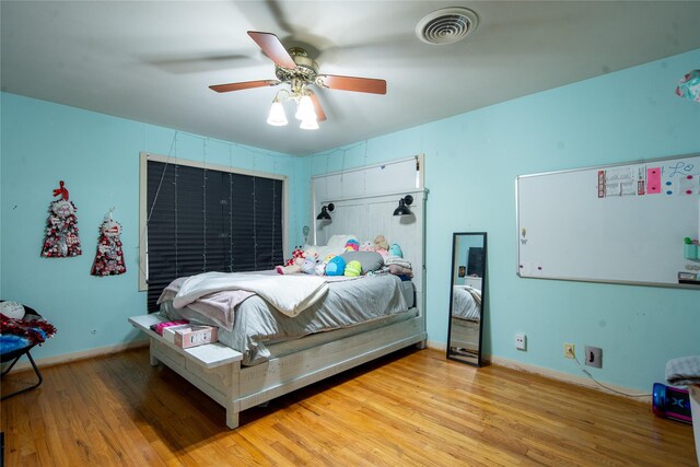 bedroom with ceiling fan and light wood-type flooring