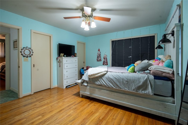 bedroom with ceiling fan and light wood-type flooring