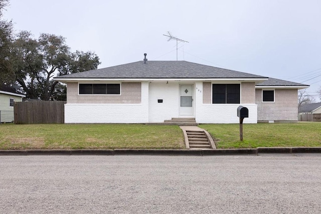 ranch-style home featuring a front yard