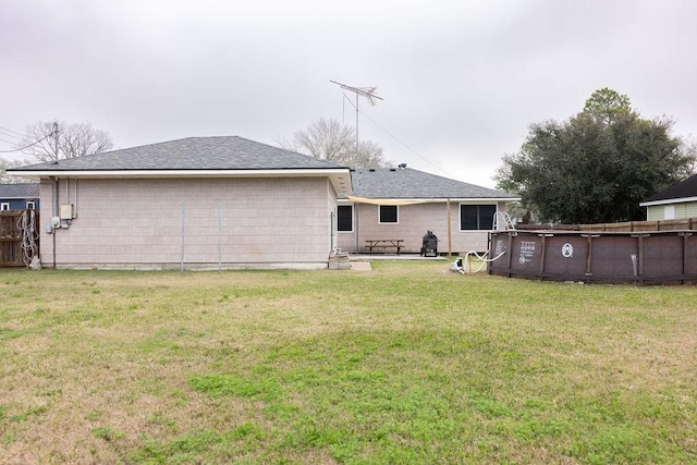 back of property featuring a lawn