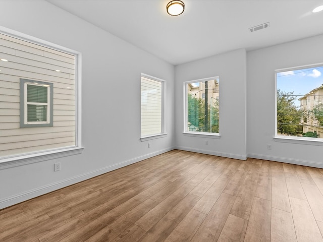 empty room with light hardwood / wood-style flooring