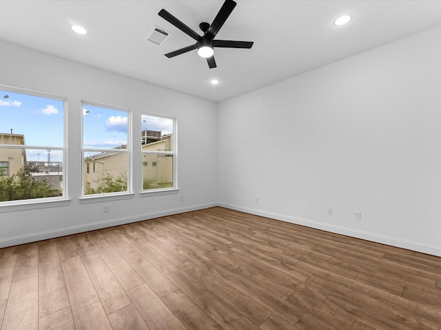 spare room with wood-type flooring and ceiling fan