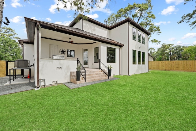 rear view of house featuring ceiling fan, a patio area, a lawn, and central air condition unit