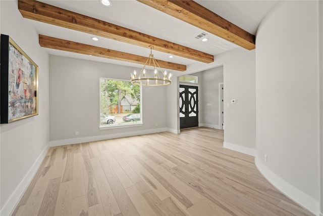 empty room with a notable chandelier, beam ceiling, and light wood-type flooring