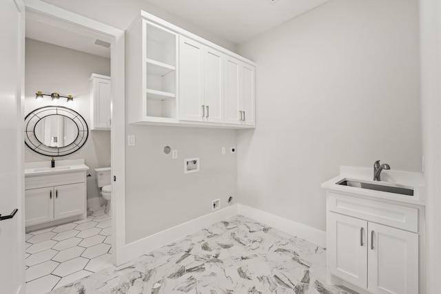 washroom featuring cabinets, washer hookup, sink, and hookup for an electric dryer