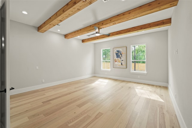 spare room featuring beam ceiling, ceiling fan, and light wood-type flooring