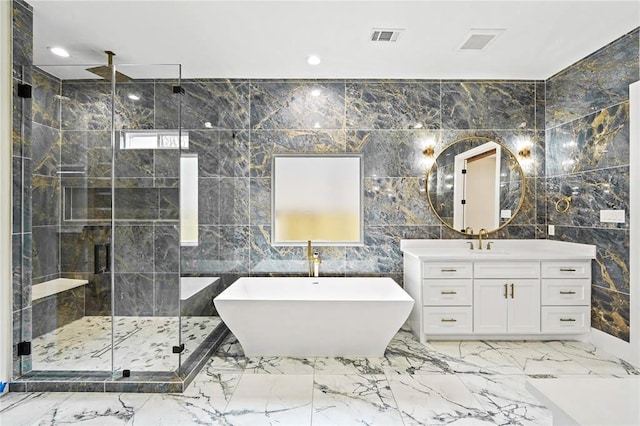 bathroom featuring tile walls, vanity, and separate shower and tub