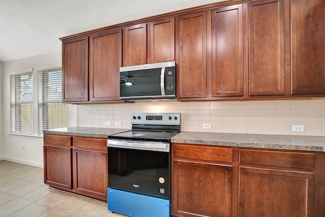 kitchen featuring tasteful backsplash, ceiling fan, appliances with stainless steel finishes, and light tile patterned flooring