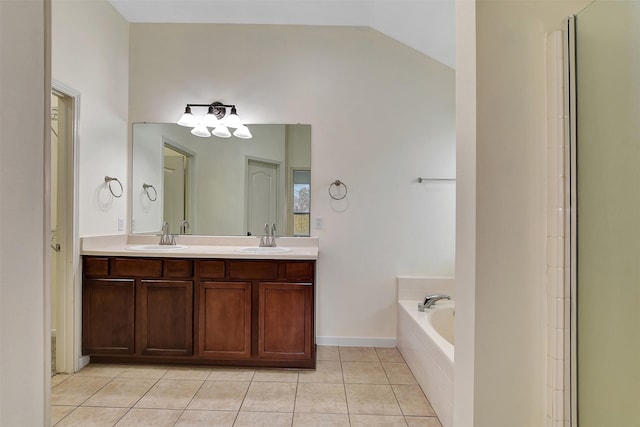 bathroom with tiled tub, vaulted ceiling, tile patterned floors, and vanity