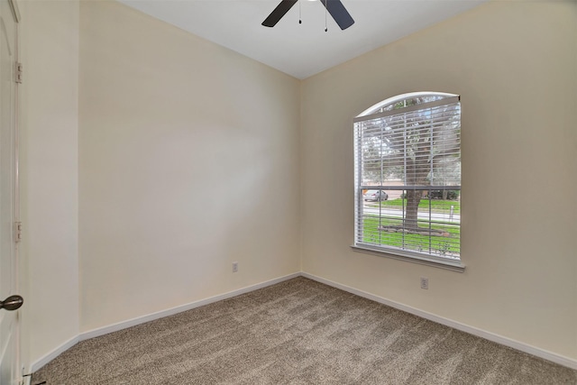 carpeted spare room with ceiling fan