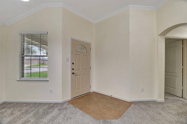 entrance foyer with light colored carpet, ornamental molding, and lofted ceiling