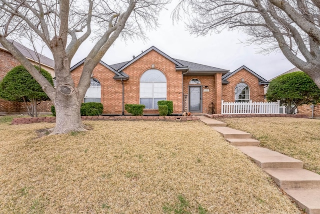 ranch-style home with a front yard