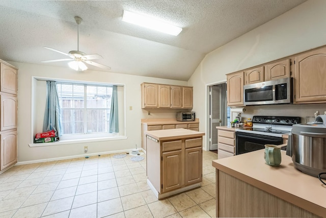 kitchen featuring a center island, vaulted ceiling, light tile patterned floors, light brown cabinets, and range with electric stovetop