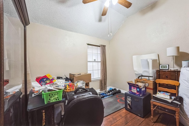 office with ceiling fan, a textured ceiling, vaulted ceiling, and wood-type flooring