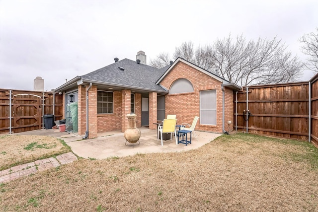 rear view of property with a patio and a yard