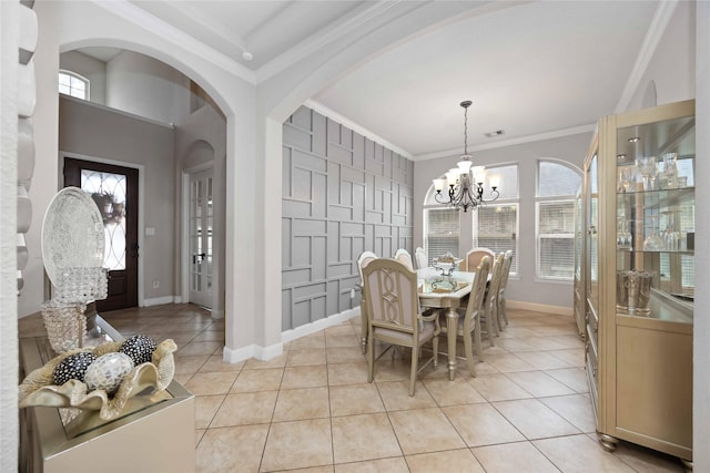 dining room featuring ornamental molding, light tile patterned floors, and a chandelier