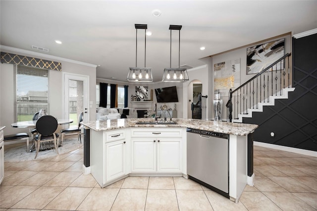 kitchen featuring sink, a center island with sink, stainless steel dishwasher, pendant lighting, and light stone countertops