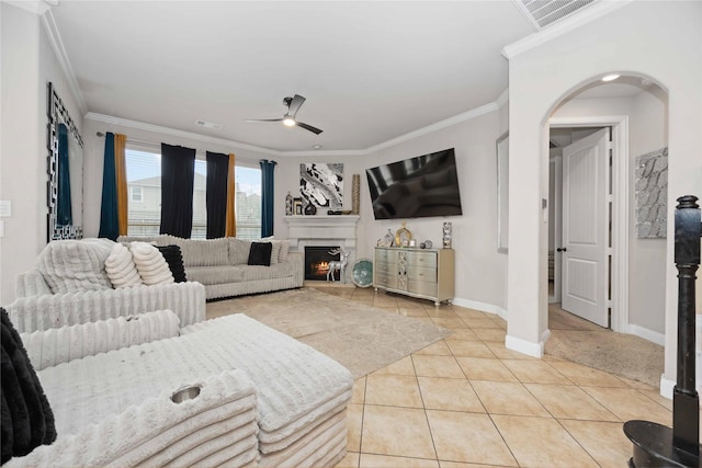 living room featuring ceiling fan, ornamental molding, and light tile patterned floors