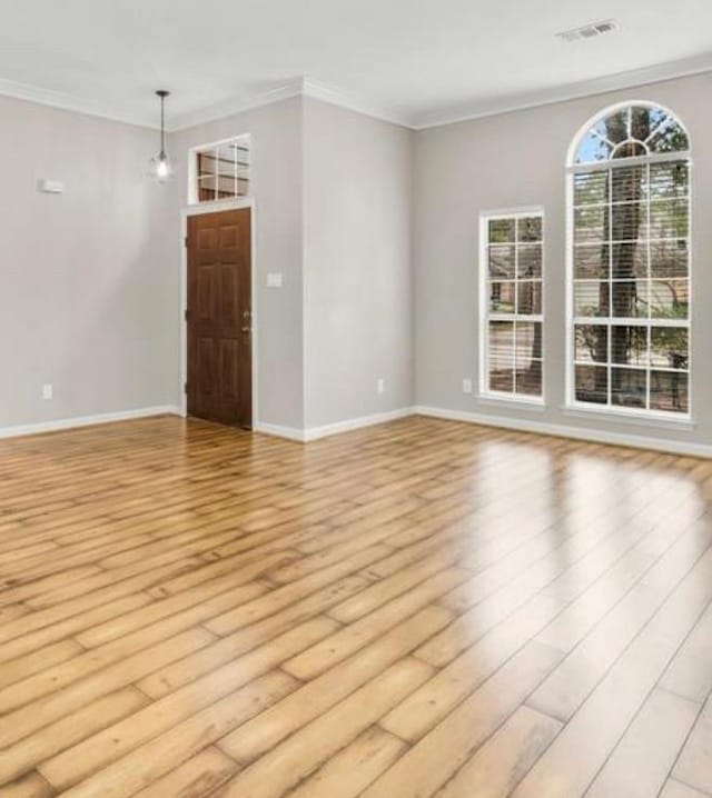 interior space featuring ornamental molding and light hardwood / wood-style flooring