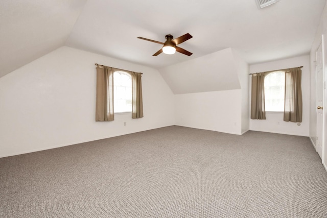 additional living space with carpet floors, ceiling fan, plenty of natural light, and vaulted ceiling