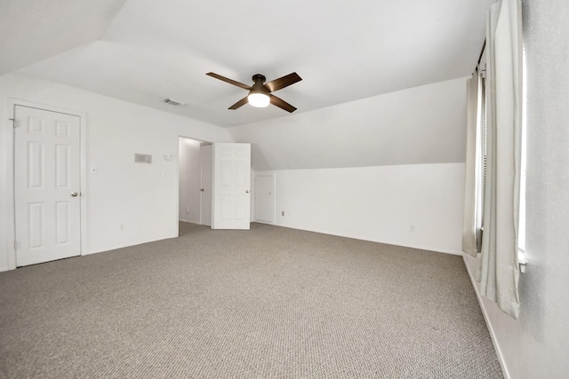 additional living space featuring ceiling fan, lofted ceiling, and carpet floors