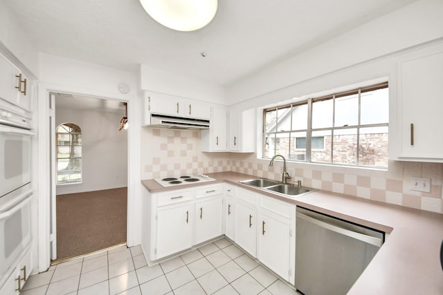 kitchen featuring white appliances, sink, decorative backsplash, and white cabinets