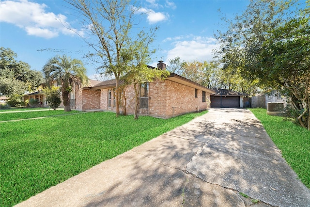 ranch-style home featuring a garage and a front lawn