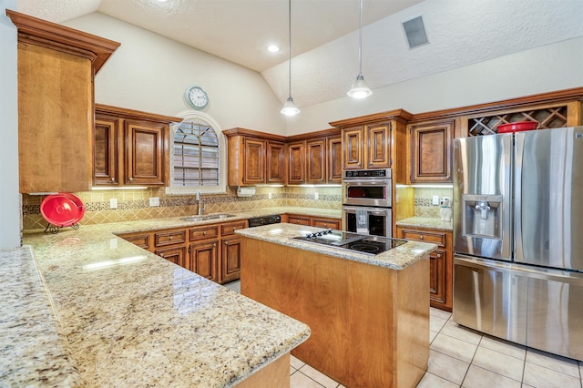 kitchen with pendant lighting, sink, lofted ceiling, appliances with stainless steel finishes, and a center island