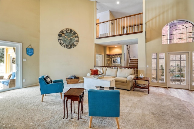 living room with light carpet and a high ceiling