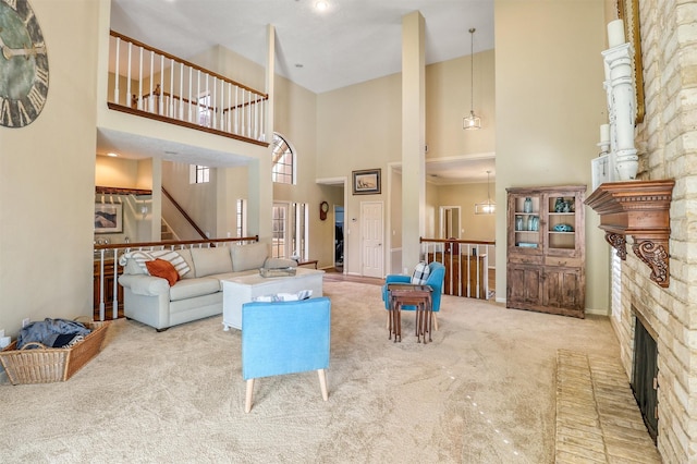 living room with carpet floors, a fireplace, and a high ceiling