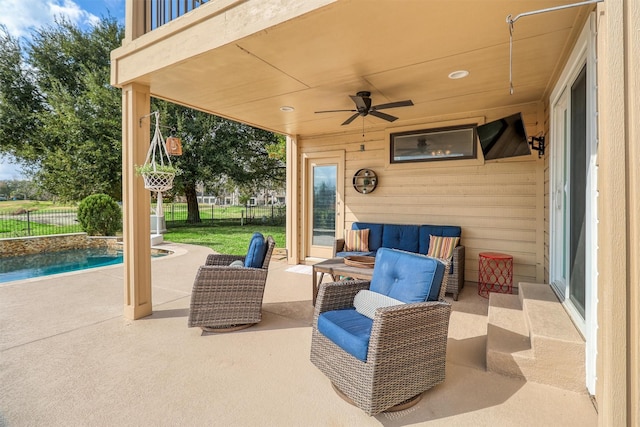 view of patio / terrace featuring a fenced in pool, a balcony, and ceiling fan