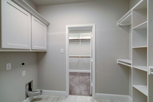 washroom with cabinets and hookup for an electric dryer