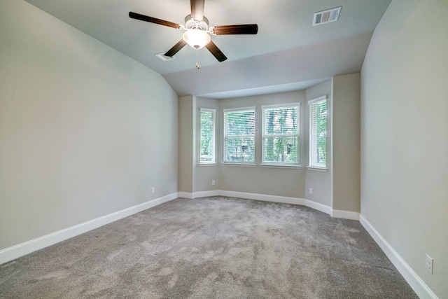 unfurnished room featuring ceiling fan, light colored carpet, and lofted ceiling