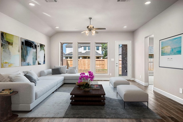 living room with dark wood-type flooring and ceiling fan