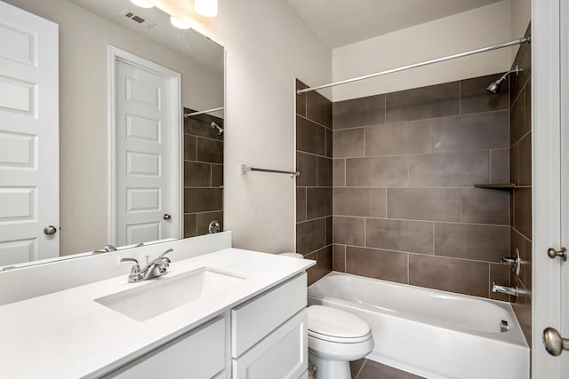 full bathroom with vanity, toilet, and tiled shower / bath