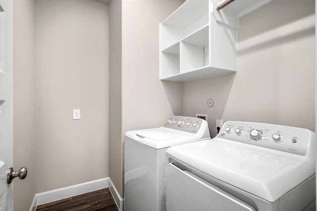 washroom featuring washing machine and clothes dryer and dark hardwood / wood-style flooring