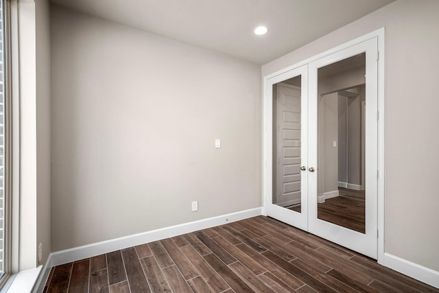 unfurnished room with dark wood-type flooring and french doors